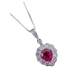 GIA Burma Ruby Pear-Shaped Pendant with Diamonds in Platinum Ruby and Diamond Pendant Necklace features a 2.02 carat Pear-shaped Red Ruby surrounded by 12 Natural Round Brilliant Diamonds, with Round Diamonds in the bale, all set in Platinum on a Platinum chain. The Ruby originates from Burma(Myanmar) and has been heated. Ruby weight is 2.02 carats and is GIA certified (please see copy of certificate in the photo gallery). Total Diamond weight is .58 carats. All diamonds are clean, lively stones. Necklace measures 18 inches long. Pendant measures .50 inch wide and .85 inch long (includes bale). The entire necklace weighs 5.1 grams. Set in Platinum. Marked Pt, 2.02, 0.58 on the pendant and Pt850 on the chain. BUY WITH CONFIDENCE Authenticity is guaranteed for every item we sell. Pear-shaped Ruby Necklace For Anniversary, Fine Jewelry Pear-shaped Ruby, Fine Jewelry Ruby Pear-shaped, Luxury Ruby Necklace With Diamond Cut, Luxury Vintage Ruby Necklace, Pear Shaped Pendant, Platinum Chain, Diamond Pendant Necklace, Round Brilliant