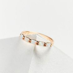 Experience the subtle sparkle and delicate beauty of our Opal Baguette Band. Made with precision-cut opal baguette stones, this stacking ring adds a touch of etheral glow to your ring stack. 14k gold plated brass 5 lab created opals 3 mm wide Questions about Shipping & Returns? Baguette Opal Ring, Elizabeth Stone, Baguette Band, Ring Stack, Delicate Beauty, Bag Icon, Icon Collection, Charm Rings, Opal Ring