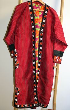 Vintage original kaftan from Turkmen people, Central Asia, with nice embroidery. On the sides and rims the coat has an elaborate embroidered Oriental pattern. The ceremonial coat is worn open and has therefore no buttons, hooks, nor belt. The inside is lined with blue-yellow cotton fabric with a floral print. In very good condition, no signs of heavy wear or repairs.  Size: comparable to European size L shoulder width: 48 cm chest: 56 cm sleeve length: 50 cm cuff width: 13 cm total length: 116 c Traditional Red Long Sleeve Kaftan, Festive Long Sleeve Kaftan With Woven Motifs, Traditional Patterned Tunic Kaftan For Ceremonies, Red Folk Style Kaftan For Festive Season, Red Folk Style Kaftan For Festive Occasions, Traditional Embroidered Kaftan For Festivals, Traditional Kaftan With Woven Motifs For Festival, Traditional Multicolor Kaftan With Embroidered Border, Traditional Kaftan With Woven Motifs For Festive Season