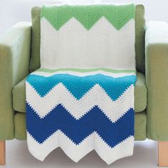 a green chair with a blue and white blanket on it