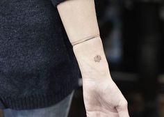 a person with a small tattoo on their wrist