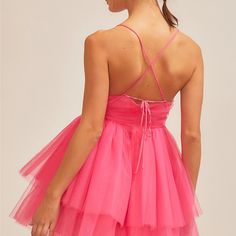 Make a big impression in the festive Back Cross Mini Organza Dress in the shade fuchsia! Perfect for that holiday party, this hot pink number features a mini tulle skirt with a crossed tie back to make sure you look gorgeous all night. Get the party started with some festive fun! Elegant Mini Dress For Bachelorette Party In Spring, Sleeveless Mini Dress For Bachelorette Party In Spring, Tie Back Mini Party Dress, Party Season Tie Back Mini Dress, Tie Back Mini Dress For Party Season, Party Season Mini Length Tie Back Dress, Flirty Mini Dress For Bachelorette Party, Pink Tutu Dress With Tulle Skirt For Prom Season, Pink Tulle Tutu Dress For Prom Season