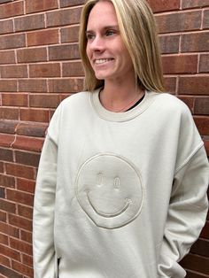 Spread all the smiles! And be on Trend with this gorgeous monochromatic KIKI crew sweatshirt featuring an embroidered smiley face graphic on the front. She is very Cozy and comfy and such a great way to brighten the day of all of the people around you! 50% Polyester 50% Cotton Fits true to size Model is 5'2" with a 25" waist, 31" hips and a 32" Bust and is wearing a small. Embroidered Smiley Face, Smiley Face Graphic, Face Graphic, Shoe Gifts, All Smiles, Crew Sweatshirts, Smiley Face, Dress Collection, Smiley