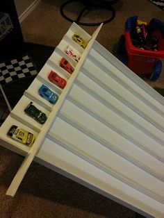 the toy cars are lined up on top of each other in this playroom area