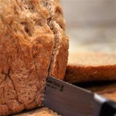 a loaf of bread being cut with a knife