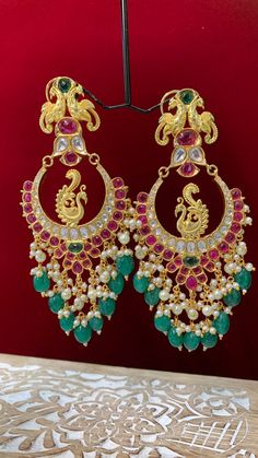 Premium quality High gold plated, pearl work, hand carved work , AD lining and kundan work. Clip back. about 5.5 inch long Absolute designer piece and statement earring. Kundan Chandbali Earrings Gold, Multicolor Chandbali Jhumkas With Cutdana, Festive Multicolor Chandbalis With Intricate Design, Temple Jewelry Style Multicolor Chandbalis For Festive Occasions, Multicolor Chandbalis With Cutdana For Diwali, Multicolor Tilla Chandbalis For Party, Multicolor Peacock Design Danglers For Festivals, Party Chandbalis With Peacock Design, Festival Multicolor Cutdana Chandbalis