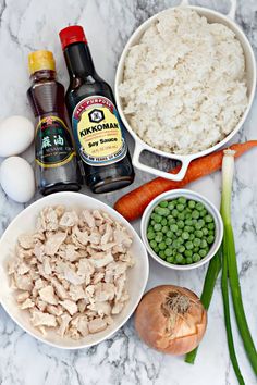 ingredients to make chicken and rice casserole laid out on a marble counter top