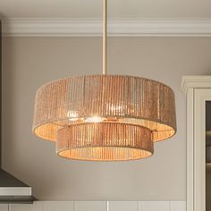 a chandelier hanging from the ceiling in a kitchen next to a stove top