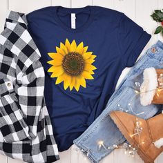 Sunflower Graphic T-shirt, Women's Fall Shirt, Floral Tee Shirt, Sunflower Shirt, Flower Shirt, Sunflower T-shirt, Sunflower Shirts, Gift Tee The majority of buyers say the shirts fit true to size, but if you prefer a tailored style or have a petite body type, ladies should size down. The shirt will have a loose, relaxed fit and significantly longer body and sleeve lengths. Please refer to the sizing chart in the photographs. No bulky sensations, simply soft, breathable t-shirts with brilliant Ink colors that will last you wash after wash. All of our clothing is screen printed directly onto the garment itself. Only BELLA + CANVAS shirts of the highest quality are used by us. 100% ringspun cotton in 4.2 oz of solid colors. The 52/48 Airlume combed and ringspun cotton/polyester are used in t Cotton Crew Neck T-shirt With Sunflower Design, Cotton Short Sleeve T-shirt With Sunflower Print, Sunflower Print Crew Neck Graphic Tee, Sunflower Print Graphic Tee With Crew Neck, Yellow Short Sleeve T-shirt With Sunflower Design, Yellow Sunflower Print Short Sleeve Top, Yellow Sunflower Short Sleeve Tops, Yellow Short Sleeve Tops With Sunflower Design, Short Sleeve Yellow Tops With Sunflower Design