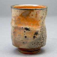 a brown and black cup sitting on top of a table