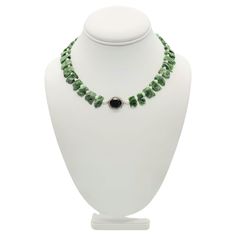 One-of-a-Kind Introducing a truly stunning necklace, featuring vivid deep green chrome Diopside gemstones. This recently discovered gemstone is found almost exclusively in Eastern Siberia and is known as Inagli. Each stone in this necklace has been expertly cut into small matching plates, with a rough texture on the top and a highly polished finish on the flat back. The arresting green of the Diopside stones is perfectly complemented by the delicate seed Pearls that separate them. The centerpiece of the necklace is a faceted Onyx, surrounded by shimmering Diamonds that add a touch of elegance and sophistication to the piece. To ensure comfort, the final 2 inches on each side of the back of the necklace feature small emeralds, Onyx, and seed pearls. The Silk hand-knotted design ensures dura Green Chrome, Rough Texture, Onyx Necklace, Seed Pearl, Stunning Necklace, Strand Necklace, Deep Green, Timeless Pieces, Onyx