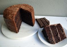 a chocolate cake with one slice cut out and the other half eaten on a plate