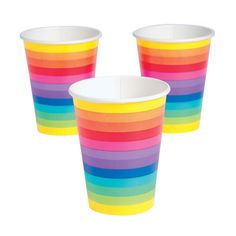 three different colored cups sitting next to each other