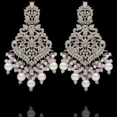 Remarkable heritage jewelry that portrays immaculate precision and technique! Exquisitely crafted earrings with pink and CZ stones along with pink moti and pearl adornments. Approximate earrings length is 4". Silver-plated on high-quality brass as base metal. Made by order. Kindly allow 5-7 weeks for the delivery of this item. For custom or urgent requests, please contact support@alacouture.com. *Please Note: We use faux stones and beads in all of our jewelry. Pink Jeweled Wedding Earrings, Pink Pearl Drop Chandbali Earrings, Pink Pearl Drop Chandbali Jewelry, Elegant Pink Chandbali Chandelier Earrings, Elegant Pink Chandbali Pearl Earrings, Elegant Pink Drop Earrings Danglers, Festive Pink Pearl Drop Earrings, Festive Pink Bridal Earrings With Pearl Drop, Elegant Pink Drop Danglers