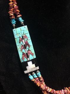 "Native American Indian, Santo Domingo Pueblo artist Raymond Rosetta's unusual handmade vintage multi-stone Corn inlay, multi-strand necklace, with turquoise, purple & orange spiny oyster, mother of pearl, jet, pin shell (backing) & sterling silver beads, including handmade stamped cones at the end before adjustable finish... Beautiful! 2 strands above Corn inlay pendants, 3 strands beneath... Corn inlay pendants are 3 3/8\" x 1 1/8\" x 3/16\" deep. 29-31\" long necklace (short strand) - Artisan Multi-strand Hand-strung Necklaces, Unique Blue Necklace With Inlay, Artisan Turquoise Multi-strand Necklace, Hand-strung Multi-strand Turquoise Necklace Gift, Unique Hand-strung Multi-strand Necklace, Artisan Double Strand Beaded Necklaces, Unique Multi-strand Turquoise Jewelry, Unique Turquoise Multi-strand Jewelry, Artisan Multi-strand Jewelry With Natural Stones