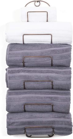 four folded towels are stacked on top of each other in a towel rack with metal handles