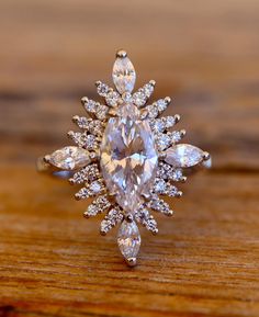 a diamond ring on top of a wooden table