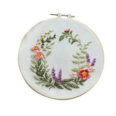 a white embroidery hoop with flowers on it