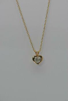 "14K Yellow Gold Diamond Heart Pendant, HSI, app .5 ct, 5mm stone floats on a white and gold mount on rabbit ear bail, chain length 18\" chain, 1.8 grams. Stock # BB127N06 This listing contains photographs of the actual item you will receive. Our items are in excellent condition with little or no signs of wear and many are one of a kind pre-owned estate finds. Please look closely at the pictures in this listing as they are part of the product description. Please read the description, as any impe Heart-shaped Yellow Gold Jewelry With Single Diamond, Gold Heart Necklace With Single Cut Diamonds For Gift, Heart Pendant With Single Diamond For Valentine's Day, Yellow Gold Heart Cut Single Diamond Jewelry, Gold Heart Necklace With Single Cut Diamonds For Anniversary, Valentine's Day Gold Jewelry With Single Diamond, Valentine's Day Single Diamond Gold Jewelry, Yellow Gold Heart Pendant With Single Diamond, White Single Diamond Heart Pendant Jewelry