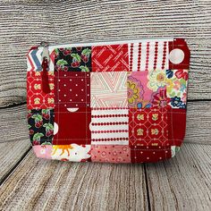 a patchwork purse sitting on top of a wooden table