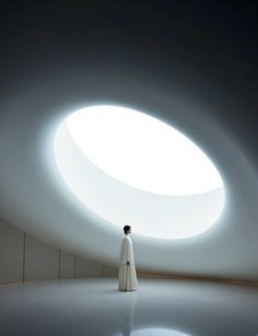 a person standing in front of a round window with light coming from it's center