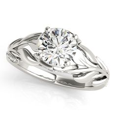 a white gold engagement ring with an intricate design