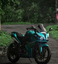 a blue motorcycle parked on the side of a road