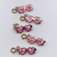 Made in the shades! Trendy Nickel-free Pink Charm Necklace, Trendy Gold Charms Nickel Free, Trendy Pink Charm Necklace For Friendship, Pink Metal Novelty Jewelry, Novelty Pink Metal Jewelry, Trendy Removable Charms For Friendship, Fun Pink Heart-shaped Jewelry, Cute Gold Charm Bracelet For Party, Playful Gold Charms For Gifts