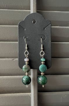 Hey beautiful souls! Let me tell you about my latest creation: these groovy green bead and silver dangle earrings.  Crafted with love, the vibrant green beads capture the essence of the lush forests, while the silver accents add a touch of moonlit magic to your look.  These earrings dangle with the rhythm of the earth, perfect for those who dance with the wind and dream with the stars.  Wear them to feel the heartbeat of nature and keep the spirit of adventure alive! They're one of a kind!  Peace and Love. Green Nickel Free Dangle Earrings, Nickel-free Green Dangle Earrings, Green Nickel-free Dangle Earrings, Green Jade Nickel-free Earrings, Nickel-free Green Jade Earrings, Green Nickel-free Jade Earrings, Sterling Silver Jewelry With Green Dangling Beads, Green Beaded Earrings With Round Beads, Green Gemstone Bead Drop Earrings