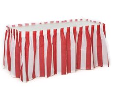 a red and white striped table cloth on top of a round table