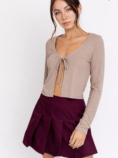 Look on trend with this front tie long sleeve top. A material so soft, It'll be your new go to shirt. Fits the wardrobe all year long, plus we love a good neutral, am I right? Solid Long Sleeve Tops For Date Night, Long Sleeve Tops For Date Night, Long Sleeve Tops For Winter Date Night, Long Sleeve Tops For Date Night In Winter, Winter Long Sleeve Tops For Date Night, Trendy Tops With Tie Sleeves For Fall, Casual Long Sleeve Top With Tie Sleeves, Fall Long Sleeve Top For Brunch, Trendy Fall Loungewear Blouse