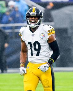 a football player standing on top of a field