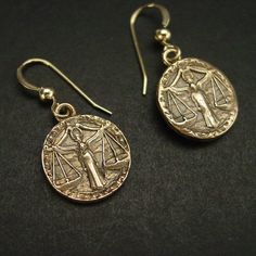 "Handmade antiqued bronze coin charms with the zodiac sign of Libra birthday gift for people born between Sept 23 - Oct 23. Libra are: Cooperative, Diplomatic, Gracious, Fair-minded, Social On those dainty earrings an angel is in the middle overlooking the scale. The concept of the zodiac originated in Babylonian astrology, and was later influenced by Hellenistic culture. According to astrology, celestial phenomena relate to human activity on the principle of \"as above, so below\", so that the Symbolic Brass Jewelry With Coin Pendant, Symbolic Bronze Jewelry With Coin Pendant, Antique Gold Symbolic Engraved Jewelry, Symbolic Engraved Antique Gold Jewelry, Gold Earrings With Antique Finish For Gift, Vintage Brass Earrings With Engraving, Vintage Brass Earrings With Engraved Details, Gold Antique Finish Drop Earrings, Stamped Metal Earrings For Gifts