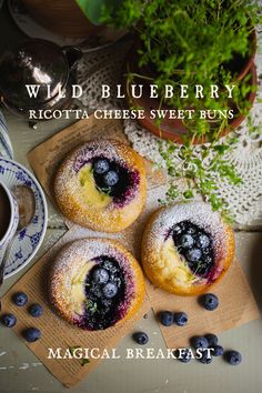 three blueberry ricotta cheese sweet rolls on a table