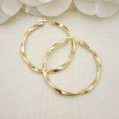 Stunning real 14k yellow gold polished 3mm thick twisted hoop earrings. Perfect for everyday and special occasions. Shiny, elegant and versatile. Perfect gift for her. A must have in your earrings collection. Materials: 14k Yellow Gold Diameter: 42mm Thickness: 3mm Weight: approximately  3.4 -3.6 grams 14k stamped Brand new  Fast shipping  Check Out our 46mm 14k Gold 3mm Twisted Hoops Earrings: https://www.etsy.com/BrizaCollections/listing/1426247742/real-14k-gold-3mm-twisted-hoops-earrings?utm_ Cheap Gold Plated Earrings For Gift, Anniversary Gold Plated Hoop Earrings With Shiny Finish, Modern Twist Hypoallergenic Hoop Earrings As Gift, Modern Twist Hypoallergenic Hoop Earrings For Gifts, Modern Twist Hoop Earrings As Gift With Polished Finish, Twisted Gold Plated Yellow Gold Hoop Earrings, Modern Twist Polished Hoop Earrings As Gift, Modern Twist Yellow Gold Hoop Earrings As Gift, Elegant Gold Hoop Earrings Cadmium-free