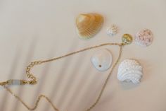 Embrace the beauty of the sea with the Summer Ocean’s Shell Necklace. This enchanting piece features a finely detailed shell pendant, perfect for adding a touch of ocean-inspired elegance to any outfit. Ideal for both casual beach days and sophisticated summer evenings, this necklace brings the serenity of the ocean to your wardrobe. Details Alloy material 14.5” chain , 2” extension extender option and a 1” dainty diffuser extender. Dainty diffuser for diffusing essential oils which can be removed if desired. Unique faux suede material will diffuse essential oils for hours. Wipe your necklace clean after wearing to preserve the life of your jewelry. Please keep dry and remove when bathing or swimming. Pearl Pendant Necklaces For Beach, Elegant Shell-shaped Charm Necklaces For Beach, Elegant Beach Jewelry With Pearl Pendant, Beach Shell Clavicle Chain Jewelry, Shell Clavicle Chain Jewelry For Beach, Beach Jewelry With Pearl Pendant In Shell Shape, Beach Shell-shaped Necklace With Clavicle Chain, Shell-shaped Pearl Pendant Jewelry For Beach, Dainty Shell Charm Necklace For Beach