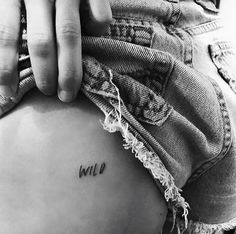 a person holding their stomach with the word wild written on it