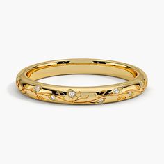 a yellow gold wedding band with diamonds