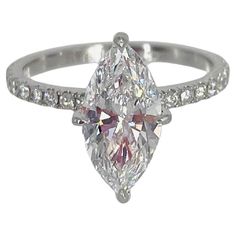 a white gold ring with a pear shaped diamond