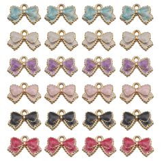 many different colored bows are shown in the shape of charms with gold chains and clasps