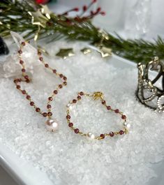 Buy individually or as a set & save!Choose from beautifully faceted Garnet rosary style chain, accented with lustrous Freshwater Pearls. Gorgeous classics with a bit of flair & color!Necklace: Rosary style faceted Garnets are accented with a lustrous 9 X 10mm Freshwater Pearl, which is hand wired to the center of the necklace. The Pearl pendant can be removed if you choose to wear them separately or the pendant on a different chain.Length: 16" with 2" extenderBracelet: Faceted Garnets are wire w Elegant Necklaces With Faceted Beads For Festive Occasions, Elegant Festive Necklaces With Faceted Beads, Elegant Jewelry With Faceted Rondelle Beads, Elegant Rondelle Jewelry With Faceted Beads, Elegant Festive Jewelry With Gemstone Beads, Elegant Gemstone Beaded Jewelry For Festive Occasions, Elegant Beaded Christmas Necklaces, Elegant Christmas Beaded Necklaces, Elegant Adjustable Christmas Necklaces