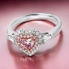 18K White Gold Fancy Vivid Pink Color Diamond Engagement Ring Natural Fancy Heart Shape Pink Color Diamond Engagement Ring With GIA certified. This Pink Diamond Ring Is A Luxurious Of Jewelry. The Center Pink Heart Of The Ring Is A Wonder Of The World, With A Unique And Stunning Color That Makes It Stand Out From Other Diamonds. Surrounding Pink Diamonds Weighing 0.10Carats, Colorless Round Diamonds With A Total Weight Of 0.20 Carats, 2 Tapered Baguette Shaped Diamonds With A Combined Weight Of 0.30 Carats, And 1 Heart Shaped Fancy Light Pink Diamond Is 0.69carat. Beautiful Pink Diamond Ring For Women.  Wearing a ring every day will make your days shine like a ring. Wear this as a daily reminder to live every moment of your life in joy.  We provide diamonds certificated by GIA. You can pur Luxury Solitaire Jewelry For Valentine's Day, Gia Certified Heart-shaped Ring For Anniversary, Heart-shaped Gia Certified Ring For Anniversary, Gia Certified Heart Shaped Anniversary Ring, Gia Certified Heart Shaped Fine Jewelry Ring, Gia Certified Heart Cut Diamond Ring, Gia Certified Heart Diamond Rings, Gia Certified Fine Jewelry Rings For Valentine's Day, Gia Certified Heart Cut Diamond Anniversary Ring