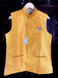 Premium quality Silk Men's Waist Coat in Yellow Color gorgeous Zari Weaving Floral designs. Can be paired with a Kurta Pajama Set. Item : Men's Jacket Ready to Wear : Yes Jacket Color : Mango Yellow Fabric : Raw Silk Work : Fancy buttons, Self Deign Pattern Material Pattern : Designer Lining : Yes Measurements of the Jacket Size - 38 Chest : 40 inches Length : 27 inches Size - 40 Chest : 42 inches Length : 27 inches Size - 42 Chest : 43 inches Length : 27 1/2 inches Size - 44 Chest : 44 inches L Transitional Wedding Nehru Jacket With Stand Collar, Festive Nehru Jacket With Stand Collar For Wedding, Fitted Nehru Jacket For Groom In Transitional Season, Fitted Nehru Jacket With Stand Collar For Transitional Season, Traditional Gold Nehru Jacket For Groom, Gold Fitted Nehru Jacket For Groom, Gold Nehru Jacket For Groom, Festive Occasion, Fitted Gold Nehru Jacket For Festivals, Gold Fitted Nehru Jacket For Festivals