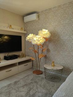 a living room filled with furniture and a flat screen tv on top of a wall