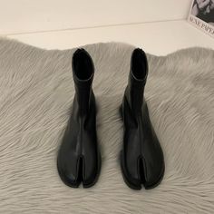 These Tabi Boots have a split toe, a flat sole, a vegan leather construction, and a back zip-up closure Material: Vegan Leather Run small, please review the sizing information Tabi Flats, Tabi Boots, Tabi Shoes, Aesthetic Shoes, Flat Boots, Short Boots, Grunge Fashion, Autumn And Winter, Ghana