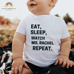 "Eat, Sleep, Watch Ms. Rachel, Repeat" funny toddler t shirt for your little one. Vinyl Colors include:   - Classic White  - Glitter White  -Classic Black - Glitter Black - Glitter Pink Please type the vinyl color you are wanting in the personalization box below This shirt is made with a soft cotton fabric that is gentle and comfortable against your baby's delicate skin | 100% cotton **WASHING / CARE INSTRUCTIONS** - Hand wash or machine wash inside-out in cold or warm water. - Mild detergent. - White T-shirt With Funny Text For Parenting, White T-shirt With Funny Parenting Text, Cute Birthday T-shirt With Custom Text, Fun Family T-shirt With Funny Text, Cute Family T-shirt With Letter Print, Cute Family T-shirt With Funny Print, Cute Custom Text Cotton T-shirt, Playful Name Print T-shirt For Mother's Day, Funny Letter Print T-shirt For Playtime