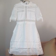 Brand New With Tags Attached, (No Price Tag) An Incredibly Cute, Fully Lined Crisp White Eyelet Dress By Simply Couture. Size Medium. Perfect 'Must Have' Bright White' Dress For Spring Thru Fall 'Outfit Of The Day' Wear. Excellent Condition. Please See All Pictures. Bust: 17.5" Measured Straight Across From Armpit To Armpit. The Waist: 15.5" Inches Measured Straight Across While Laying Flat And The Total Length Is 38" Inches Long. Chic White Hollow Out Dress, White Hollow Out Knee-length Dress, White Hollow Out Dress For Spring, Elegant Short Sleeve Mini Dress With Hollow Out, Elegant Hollow Out Mini Dress With Short Sleeves, White Hollow Out Dress For Day Out, Elegant Hollow Out Mini Dress For Brunch, White Hollow Out Mini Dress For Spring, Fitted Hollow Out Dress For Spring