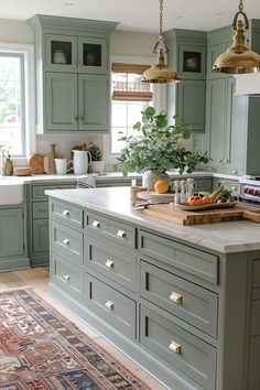 a large kitchen with green cabinets and an area rug on the floor in front of it