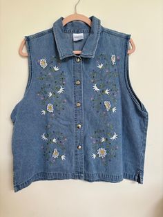 Beautiful 1980's denim vest. Beautiful embroidery  Size large Medium Wash Vest Top For Spring, Casual Embroidered Denim Vest For Spring, Spring Denim Blue Sleeveless Vest, Spring Sleeveless Cotton Denim Jacket, Casual Floral Embroidered Vest For Fall, Spring Sleeveless Denim Blue Vest, Denim Blue Sleeveless Vest For Spring, 90s Style Spring Vest, Spring Cottagecore Sleeveless Top