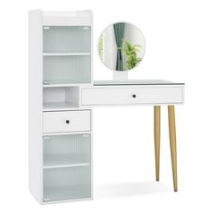 a white desk with a mirror and some drawers on it's sides next to a plant